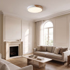 Ultra thin wood trim LED oyster ceiling light in white, mounted flush in a classic panelled living room