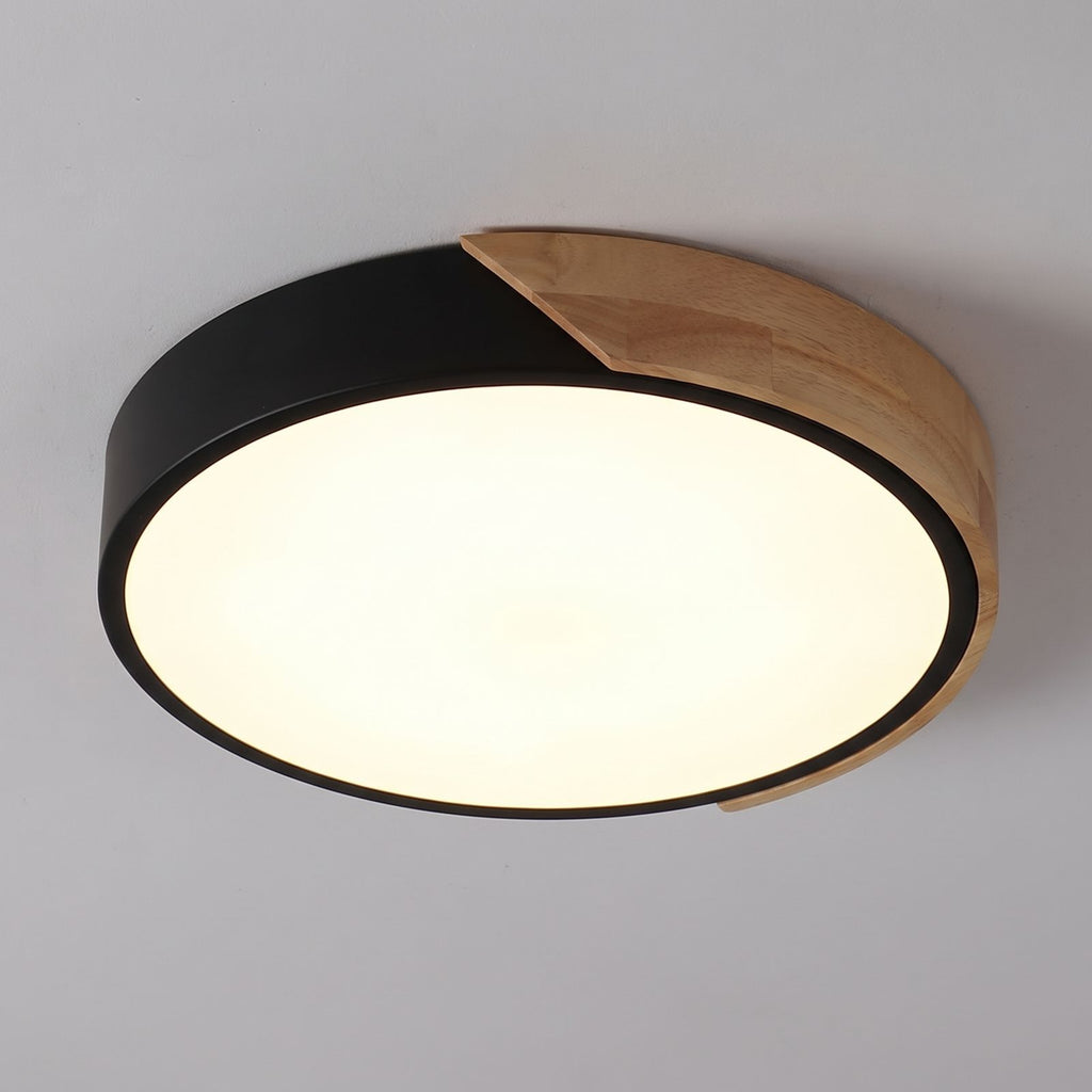 The lit face of the ultra thin LED oyster ceiling light seen from directly below, black rim