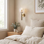 Upturned Glass Globe Wall Light on a bedroom wall beside the bed