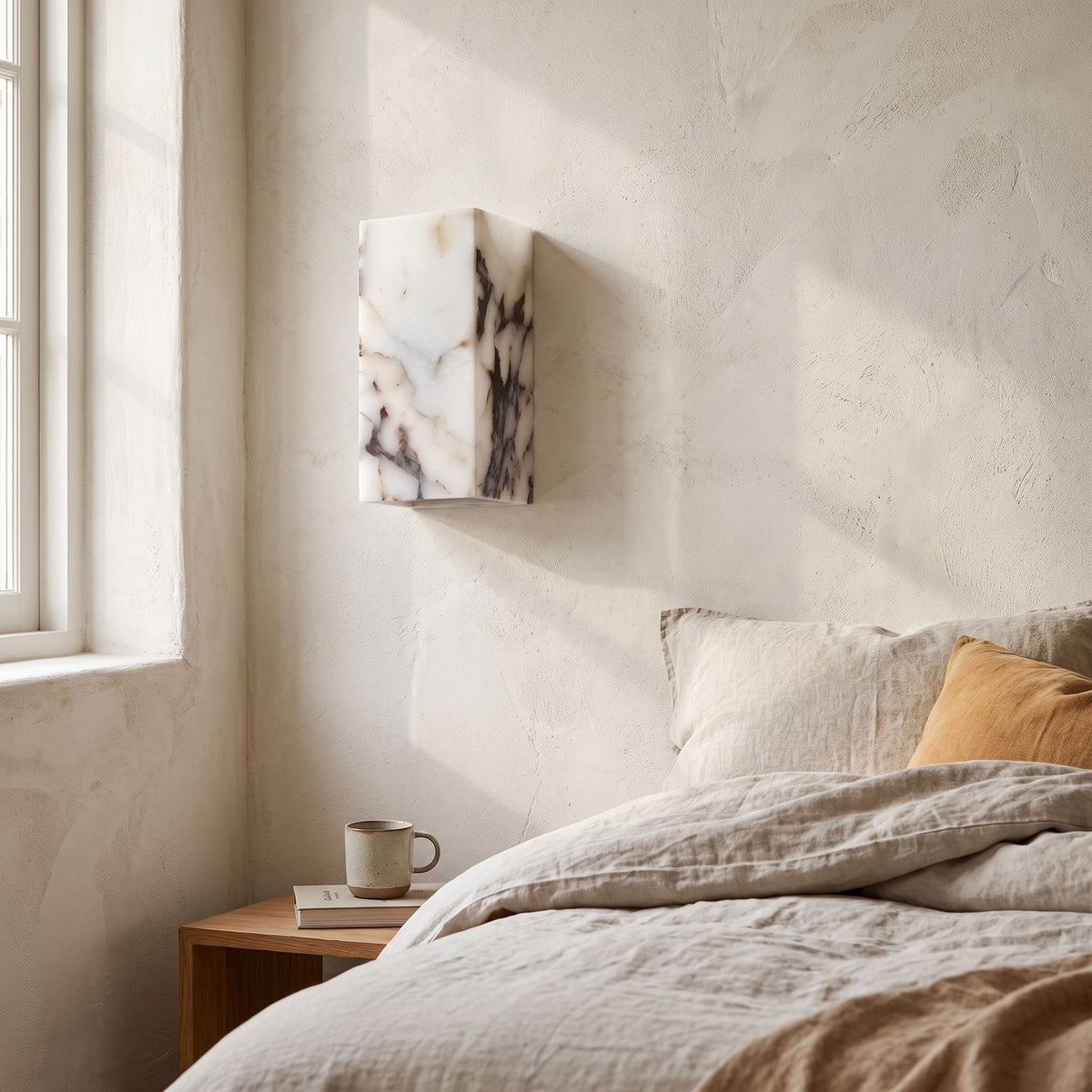 Veined Marble Block LED Wall Light on a bedroom wall beside the bed