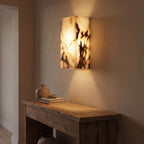 Veined Marble Block LED Wall Light in a hallway above a timber console