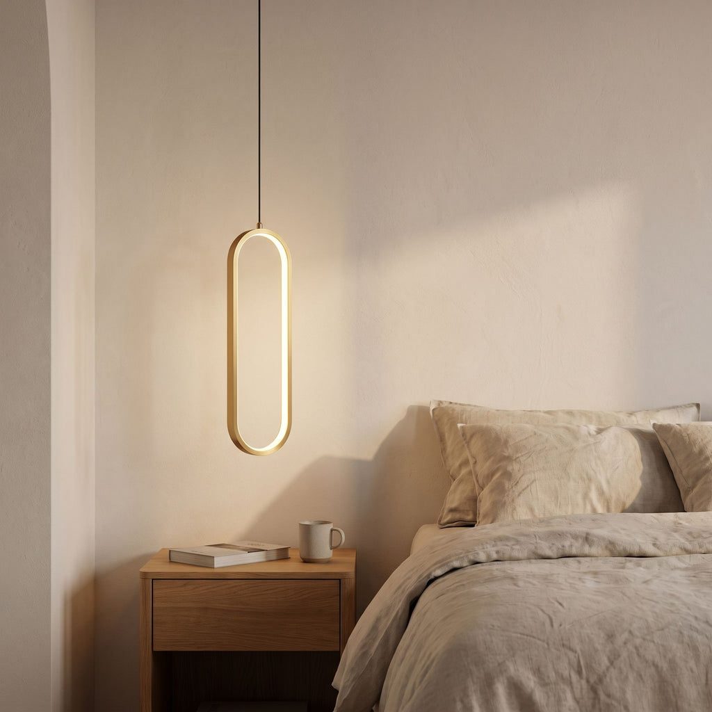 Vertical Oval Ring LED Pendant Light beside a bed