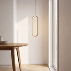 Vertical oval ring LED pendant light over a kitchen table in daylight