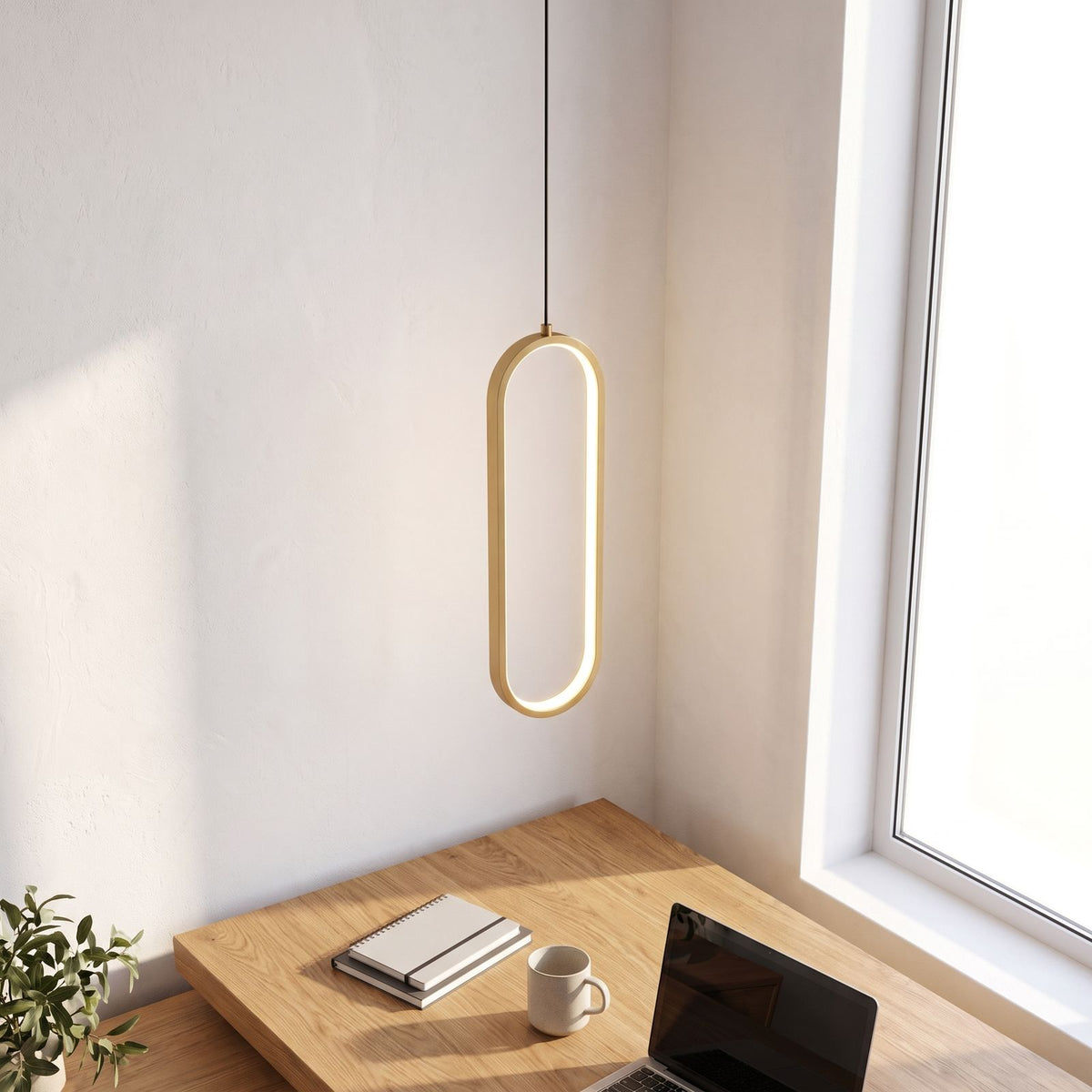 Vertical oval ring LED pendant light above a home office desk in daylight