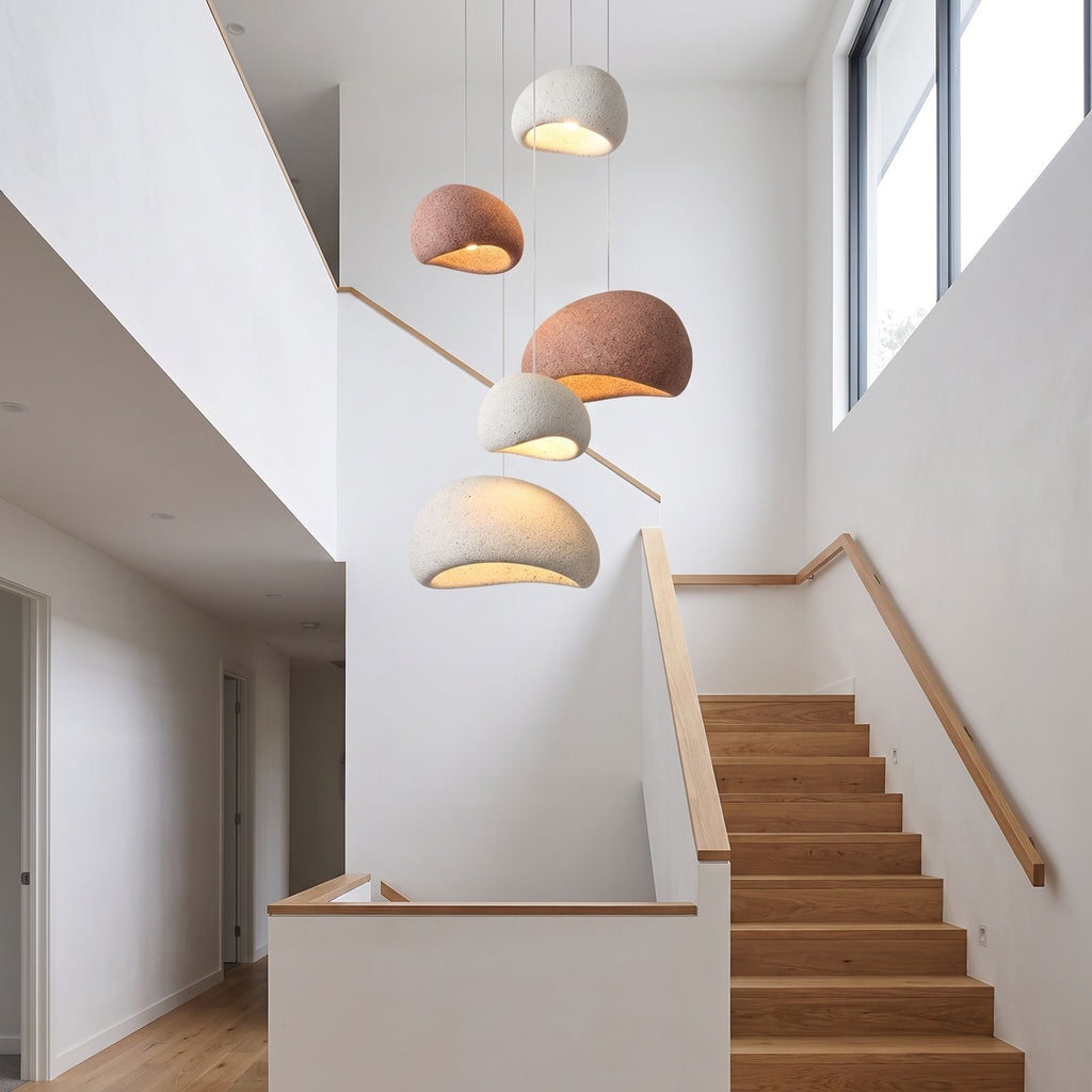 A cluster of Wabi Sabi Fibreglass Resin Pendant Lights in white and terracotta at staggered heights in a stairwell