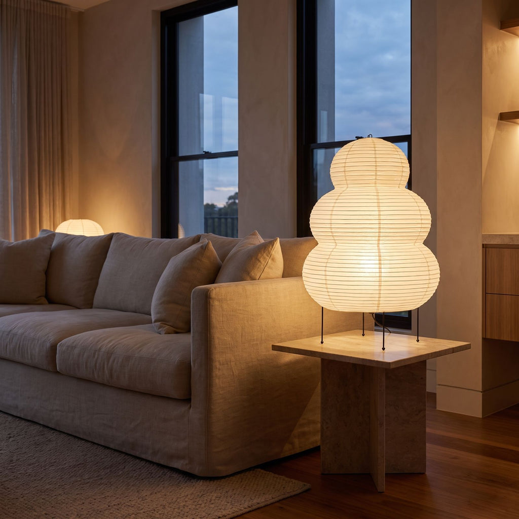 Wabi-Sabi Rice Paper Tripod Table Lamp on a side table beside a sofa