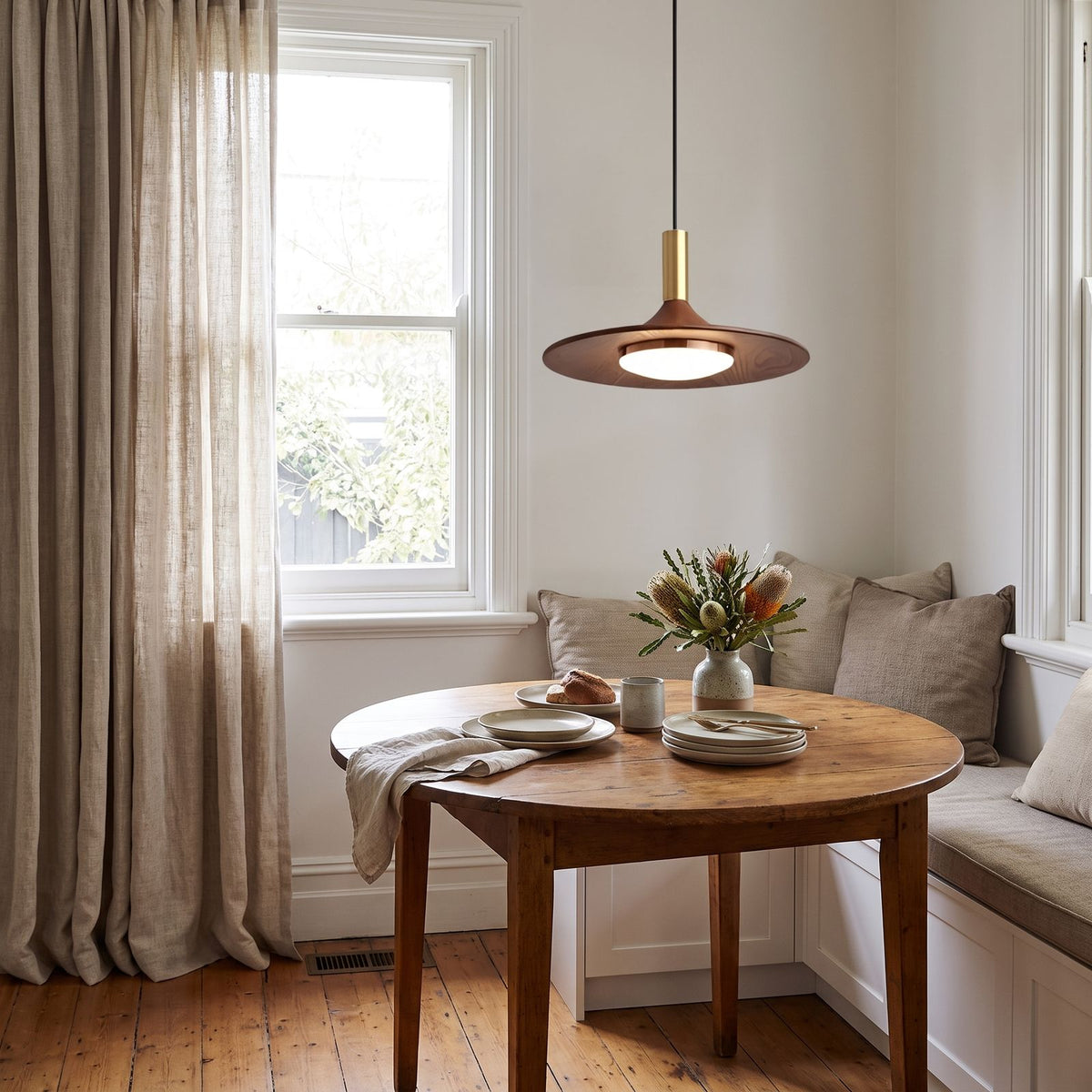 Walnut Finish Wide Brim Iron LED Pendant Light above a round table in a breakfast nook