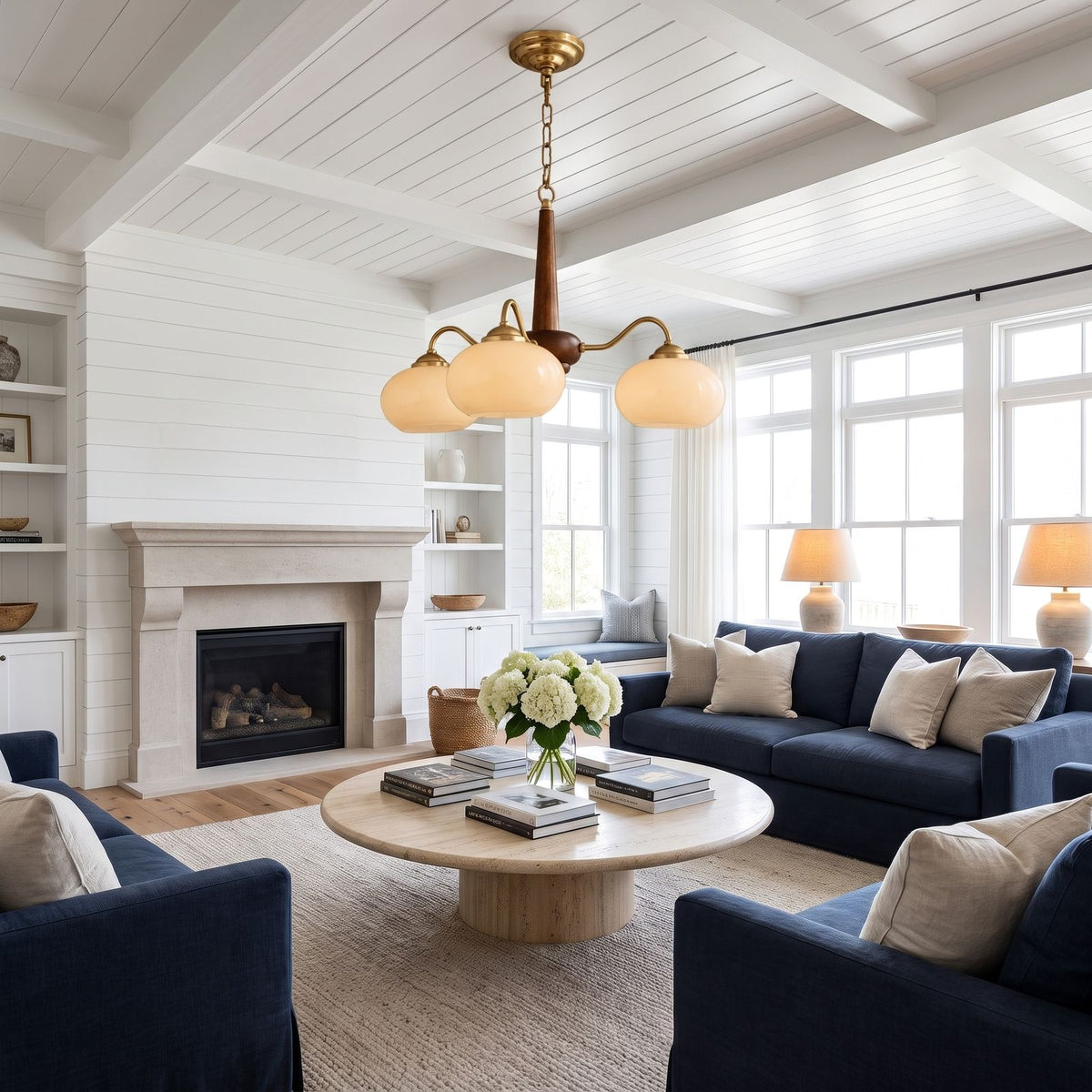 Walnut Wood and Brass Arm Glass Shade Chandelier above a coffee table in a living room in daylight