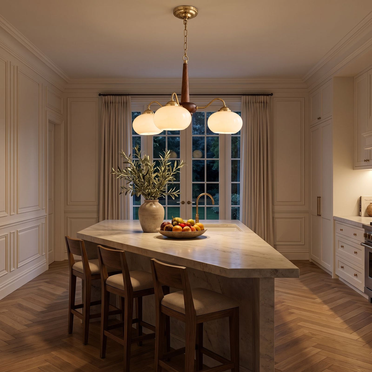 Walnut Wood and Brass Arm Glass Shade Chandelier above a kitchen island at night