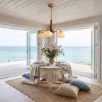 Walnut Wood and Brass Arm Glass Shade Chandelier in a styled bedroom in soft daylight