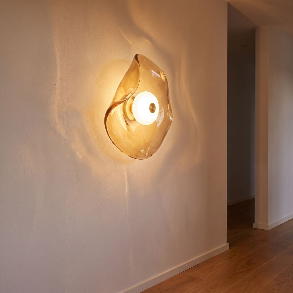 Wavy art glass disc wall light on a hallway wall