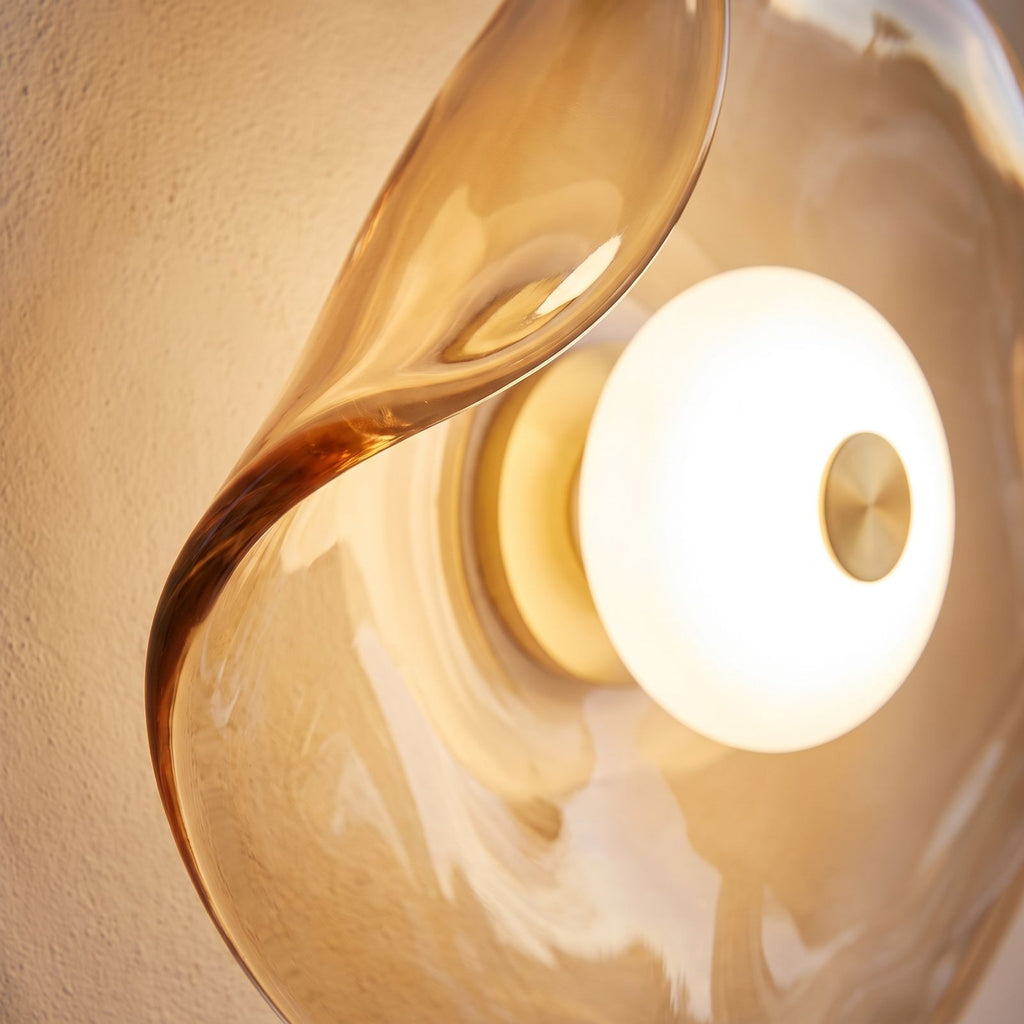 Close-up of the curled amber glass edge and LED centre