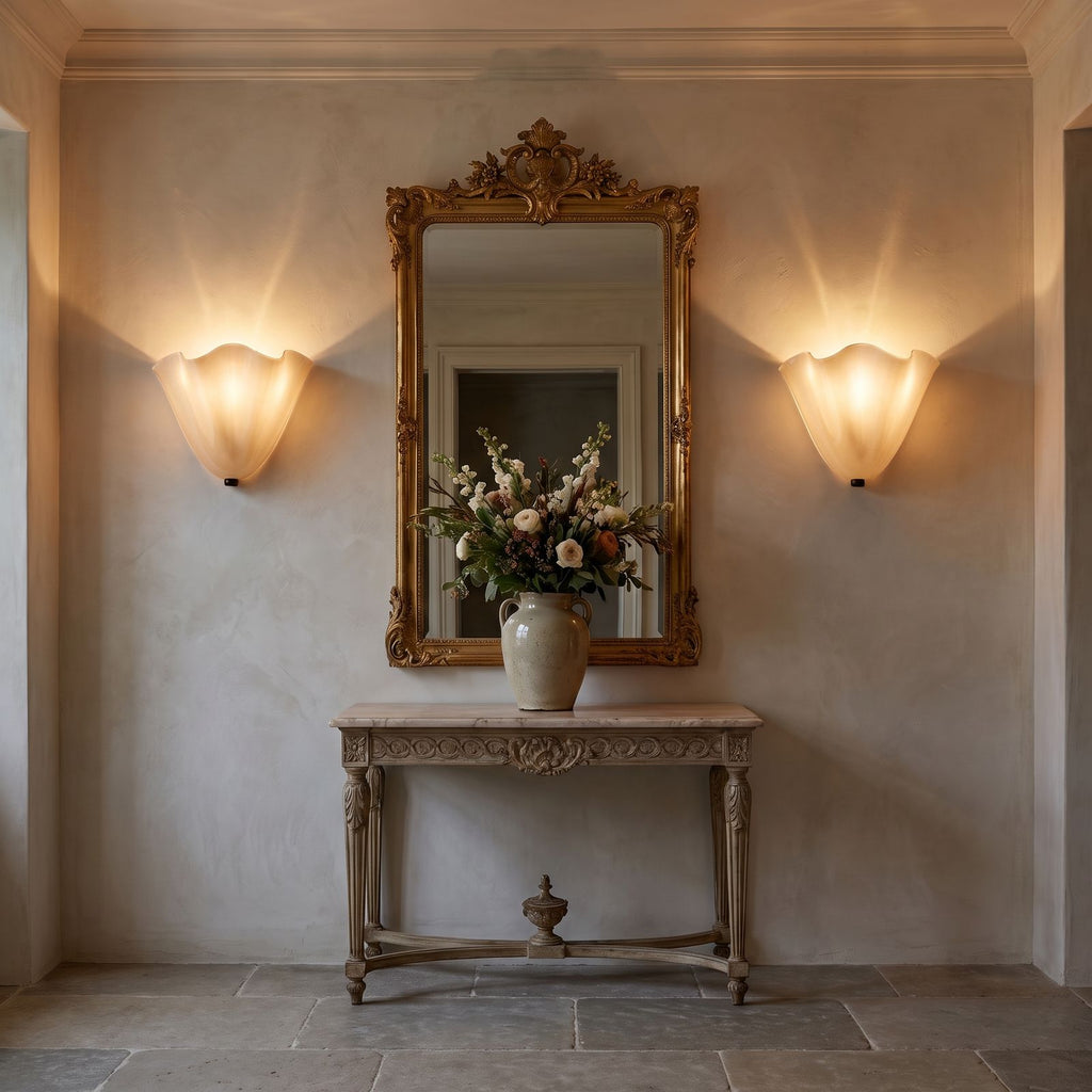 A pair of Wavy Beige Glass Shell Wall Lights either side of a mirror