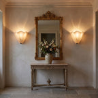 A pair of Wavy Beige Glass Shell Wall Lights either side of a mirror
