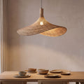 Wavy Brim Woven Bamboo Pendant Light above a dining table