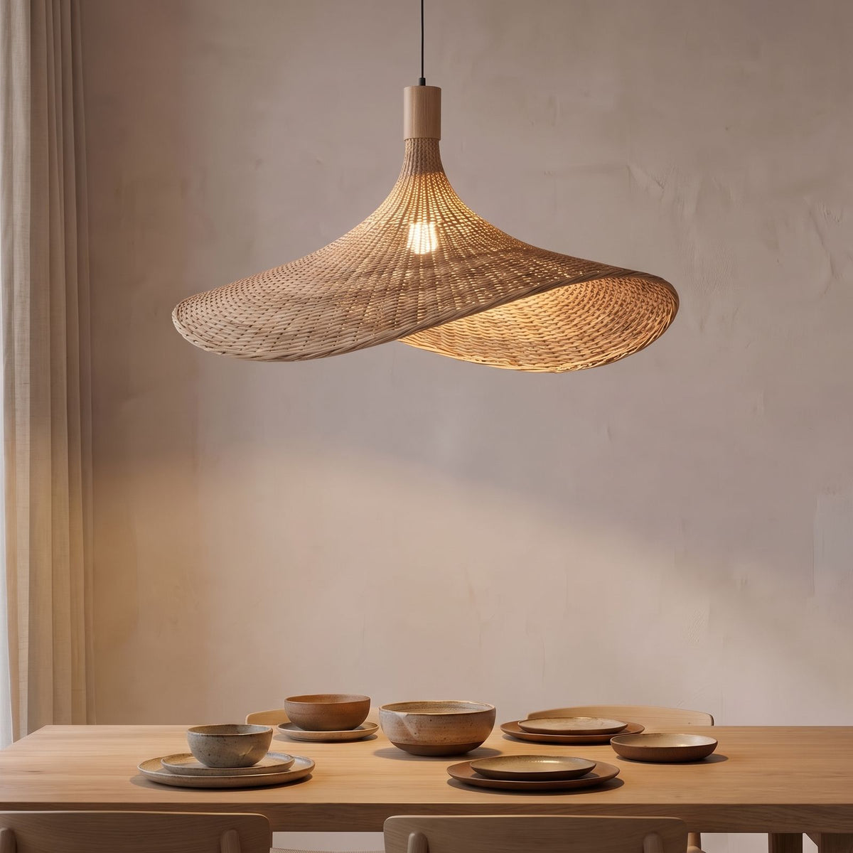 Wavy Brim Woven Bamboo Pendant Light above a dining table