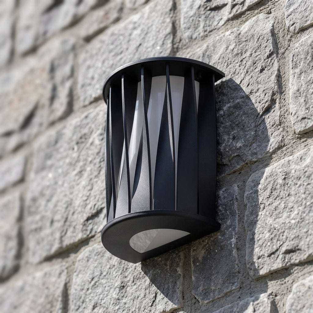 Wavy Openwork Stainless Steel Outdoor Wall Light, close view at 45 degrees on a stone wall