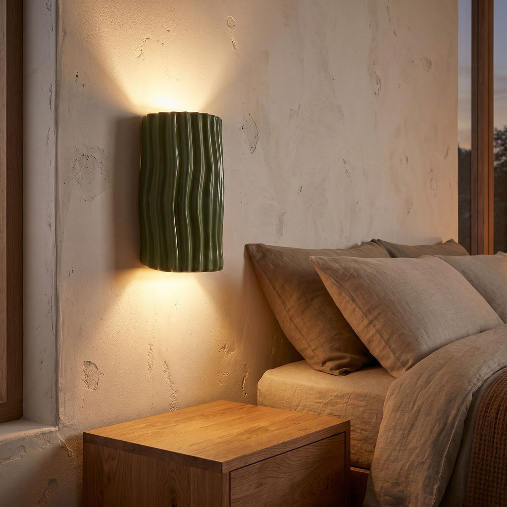 Wavy Ribbed Resin Half Cylinder Up Down Wall Light beside a bed