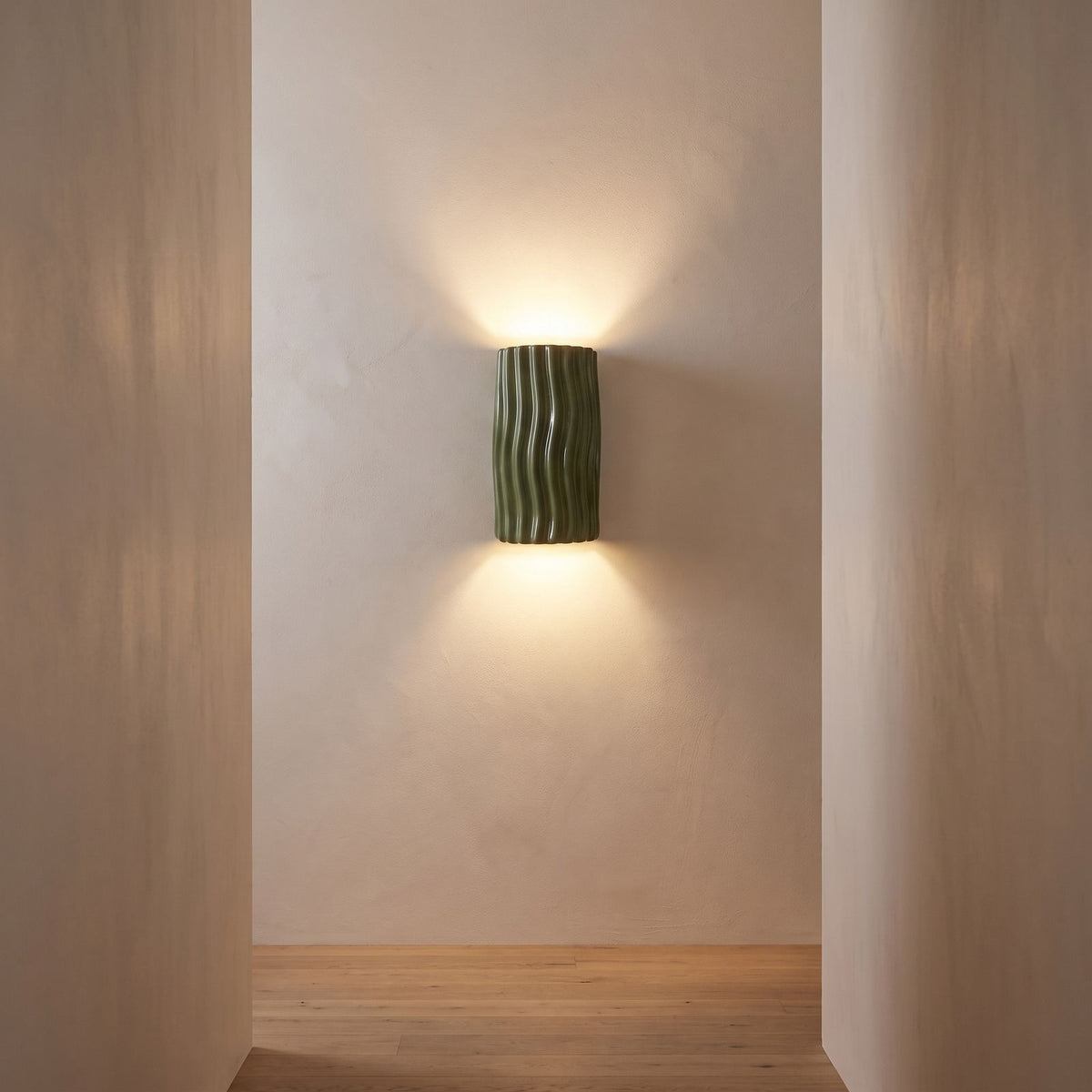 Wavy ribbed resin up down wall light on a hallway wall