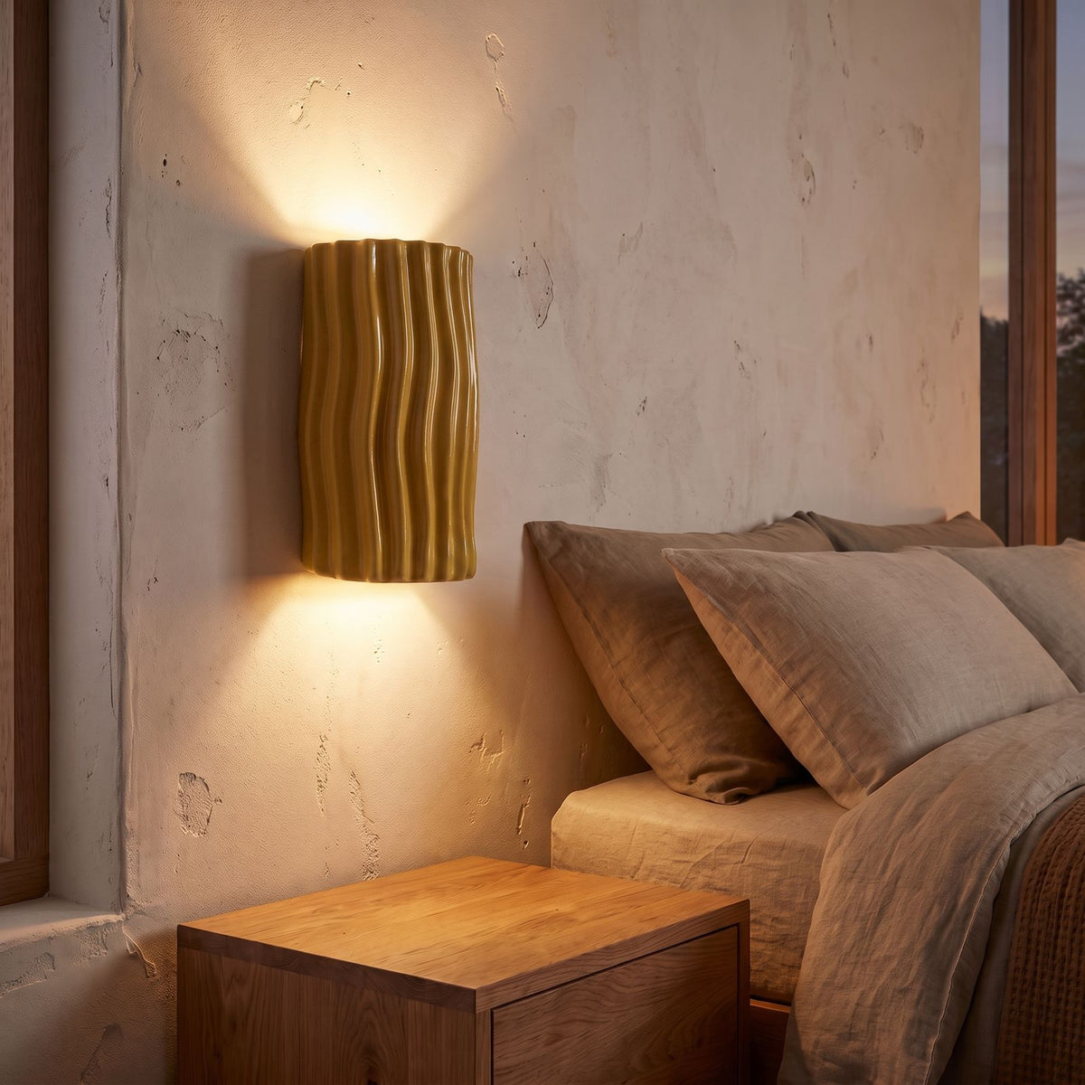 Wavy Ribbed Resin Half Cylinder Up Down Wall Light in yellow beside a bed