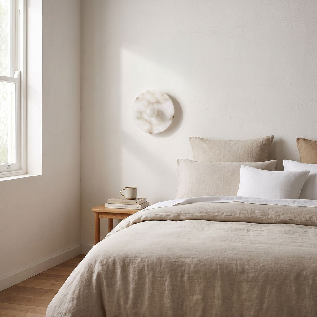 White Alabaster Halo Wall Light on a bedroom wall beside the bed