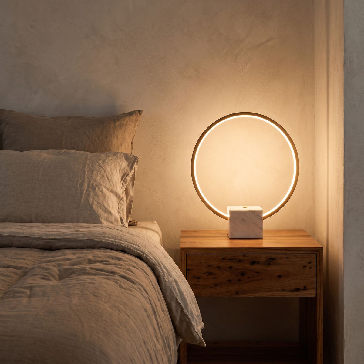 White Marble and Copper LED Table Lamp on a bedside table