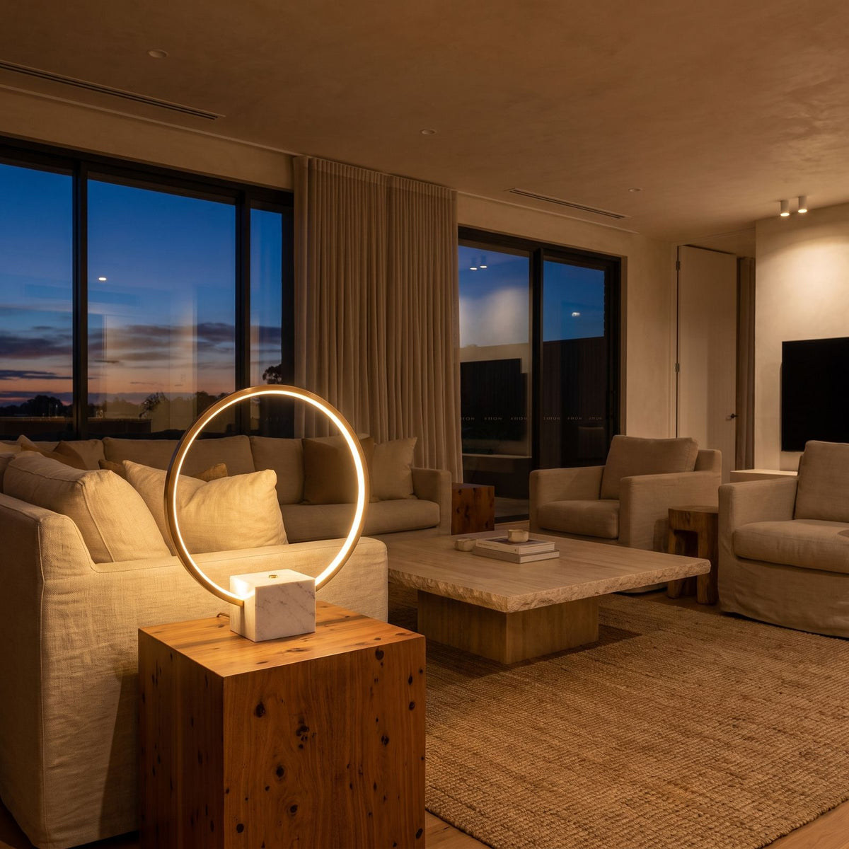 White Marble and Copper LED Table Lamp on a side table beside a sofa