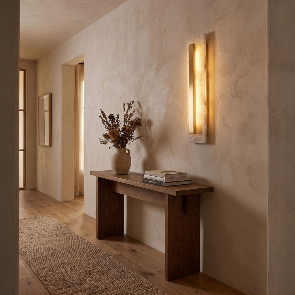 Wide Alabaster Panel Brass Wall Light in a hallway above a timber console