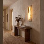 Wide Alabaster Panel Brass Wall Light in a hallway above a timber console
