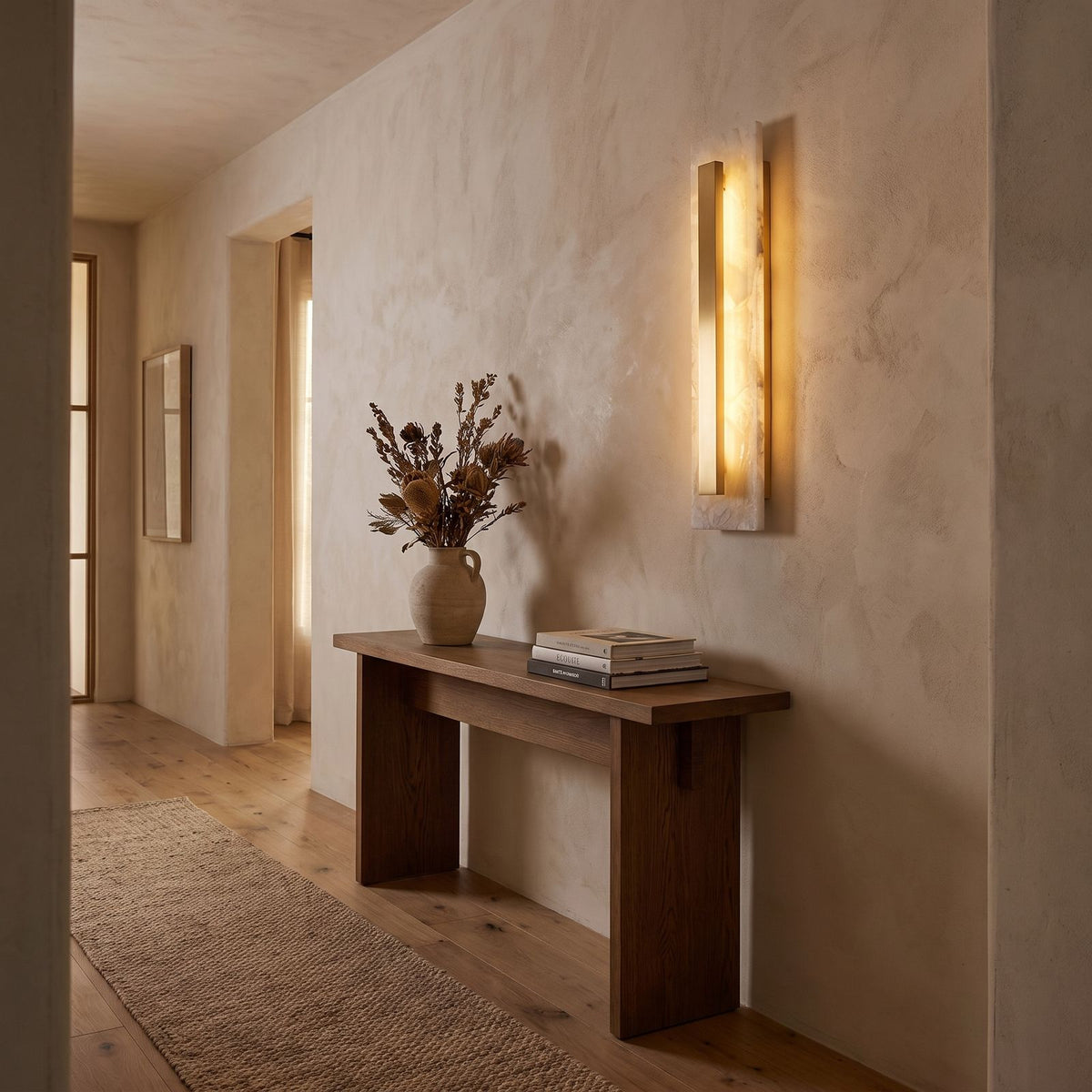 Wide Alabaster Panel Brass Wall Light in a hallway above a timber console