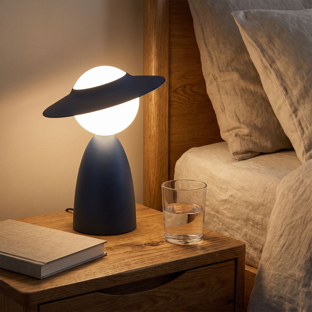 Wide Brim Hat Frosted Glass Globe Table Lamp on a bedside table