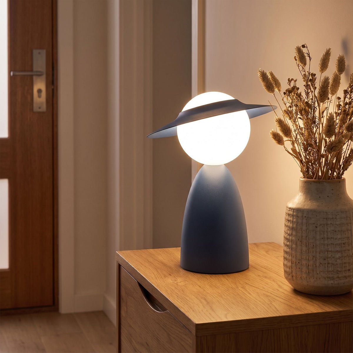 Wide brim hat glass globe table lamp on an entry console