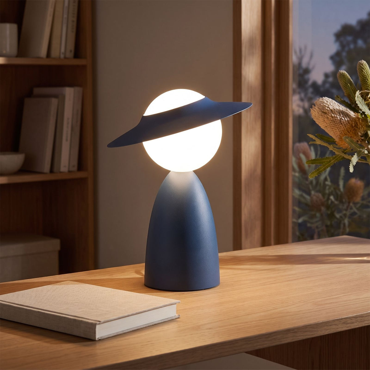 Wide brim hat glass globe table lamp on a home office desk