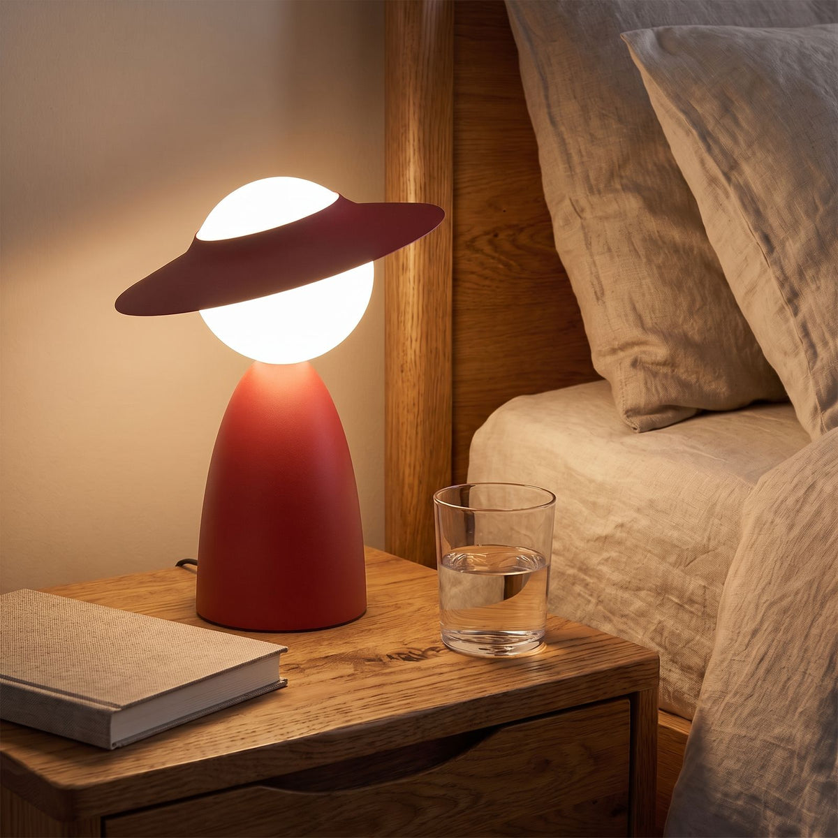 Wide Brim Hat Frosted Glass Globe Table Lamp in red on a bedside table