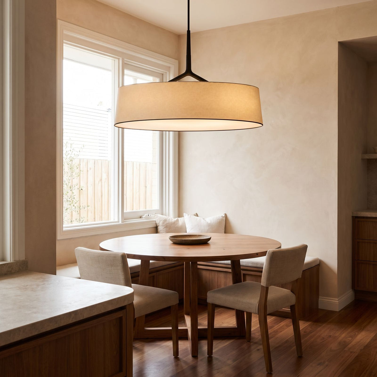 Wide Fabric Drum LED Pendant Light above a round table in a breakfast nook