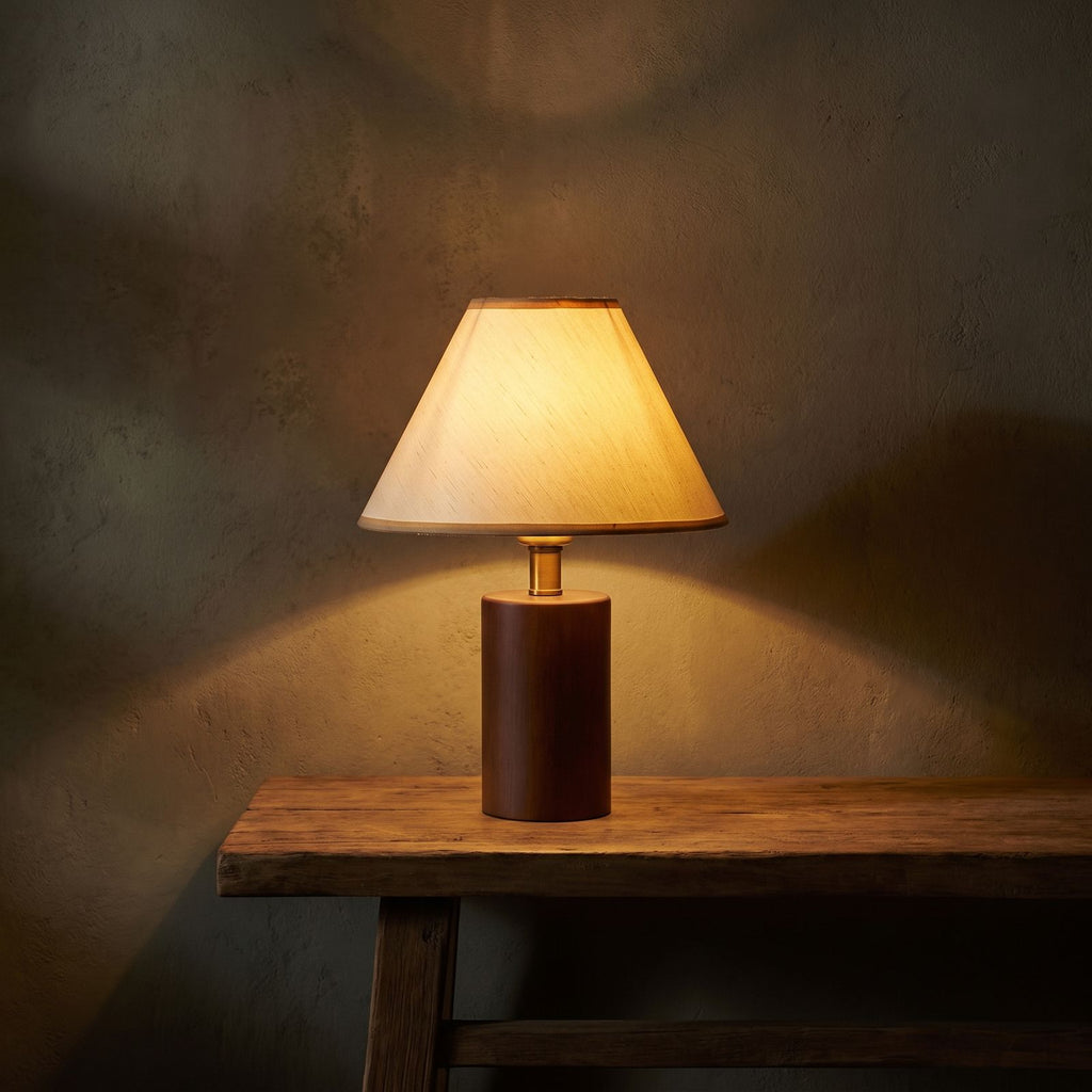 Wood Base Cone Shade Bedside Table Lamp glowing on a timber console at night