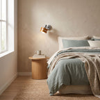 Wood Cylinder Shade Iron Disc Wall Light on a bedroom wall beside the bed