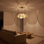 Woven Rattan Petal Flower Pendant Light, Ø60 cm, casting a soft petal pattern across a living room ceiling at night