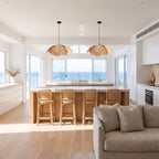 Two Woven Rattan Petal Flower Pendant Lights, Ø50 cm, above a kitchen island in a coastal beach house