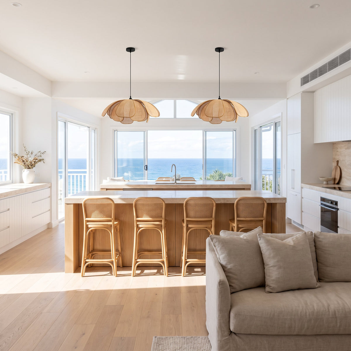 Two Woven Rattan Petal Flower Pendant Lights, Ø50 cm, above a kitchen island in a coastal beach house