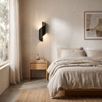 Wrap Around Aluminium and Glass Up Down Wall Light on a bedroom wall beside the bed