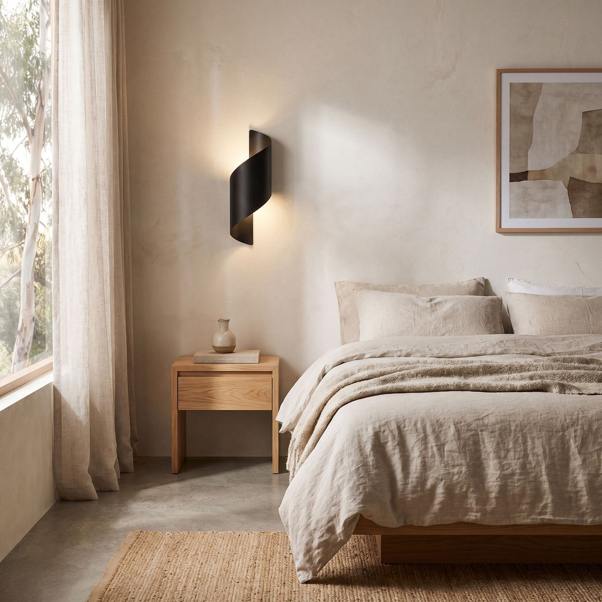 Wrap Around Aluminium and Glass Up Down Wall Light on a bedroom wall beside the bed