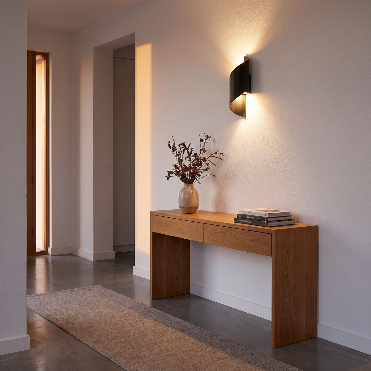 Wrap Around Aluminium and Glass Up Down Wall Light in a hallway above a timber console